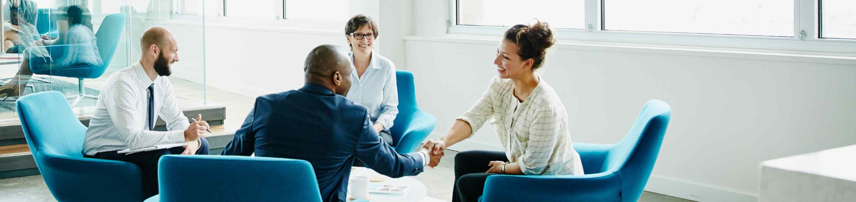 group of people shaking hands at a business meeting
