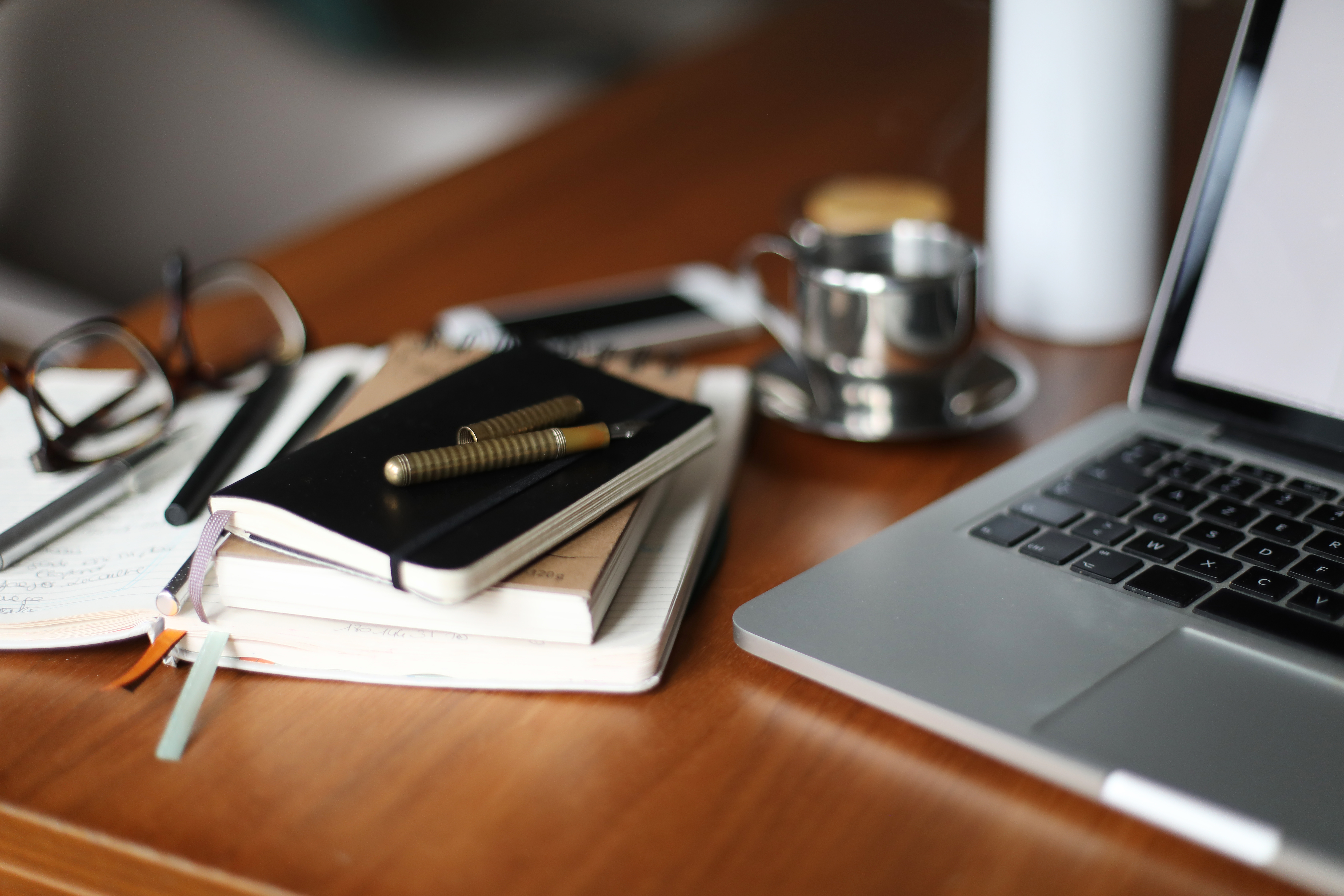 Study space with laptop and notebooks.