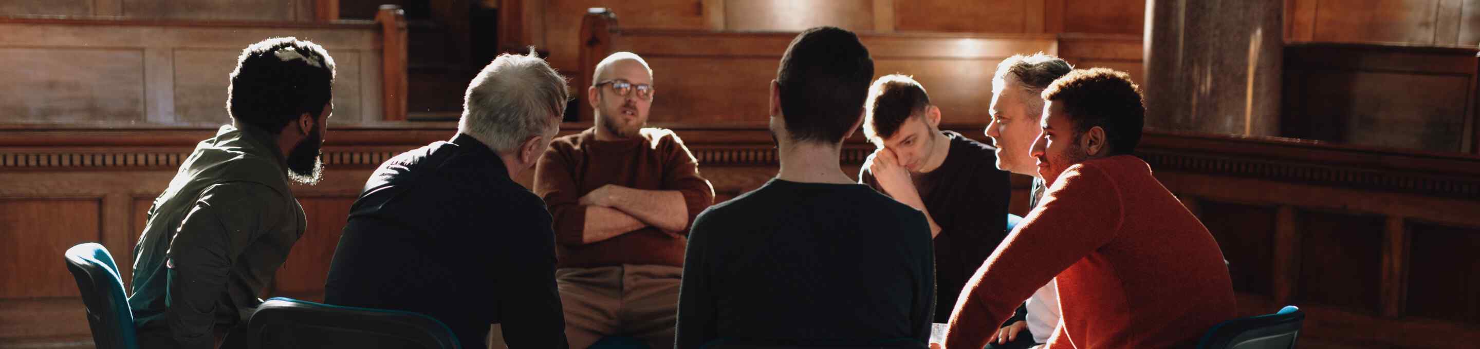 group of men talking inside a courthouse