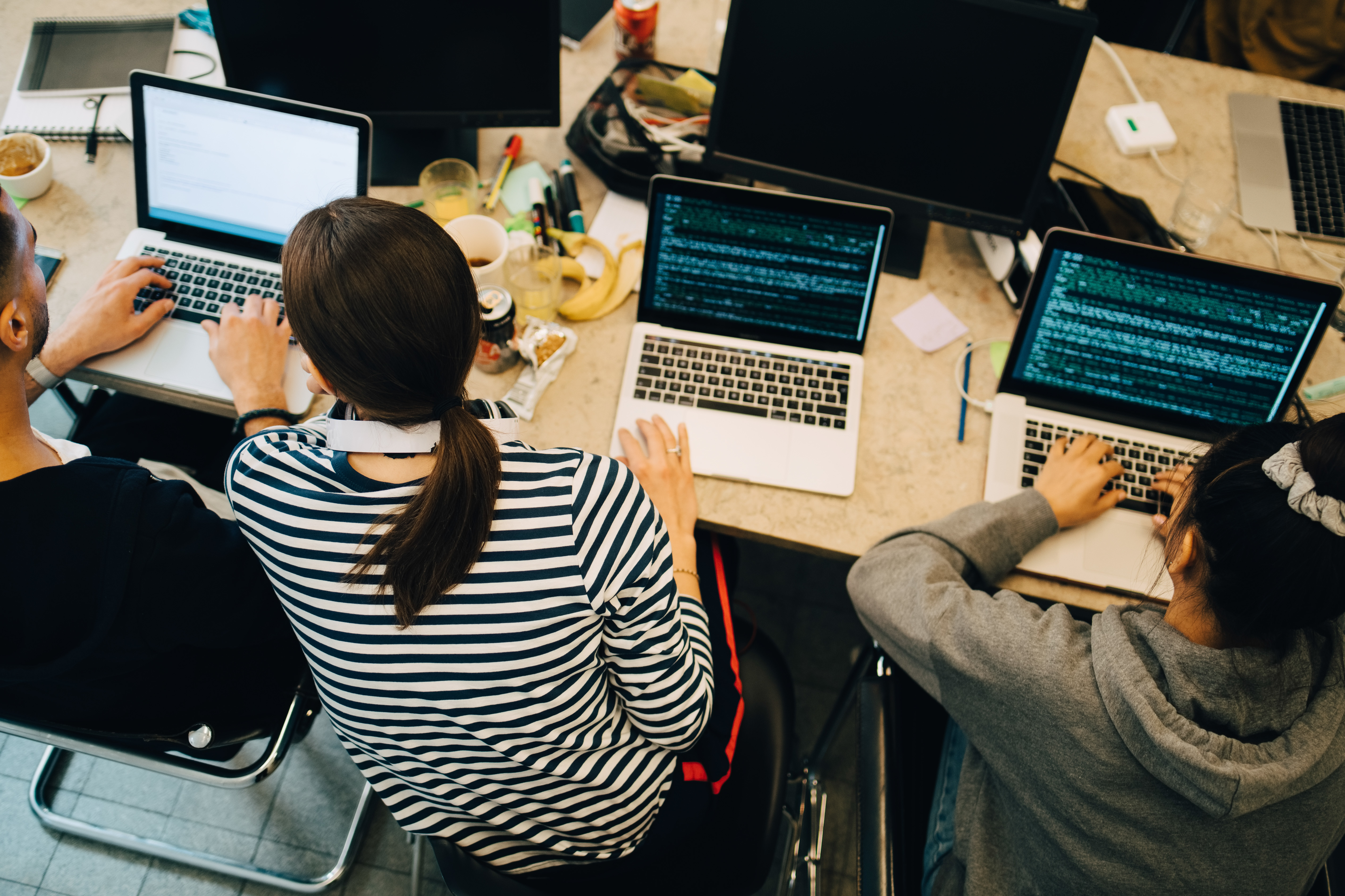 Portrayal of Capella IT student coding on a laptop