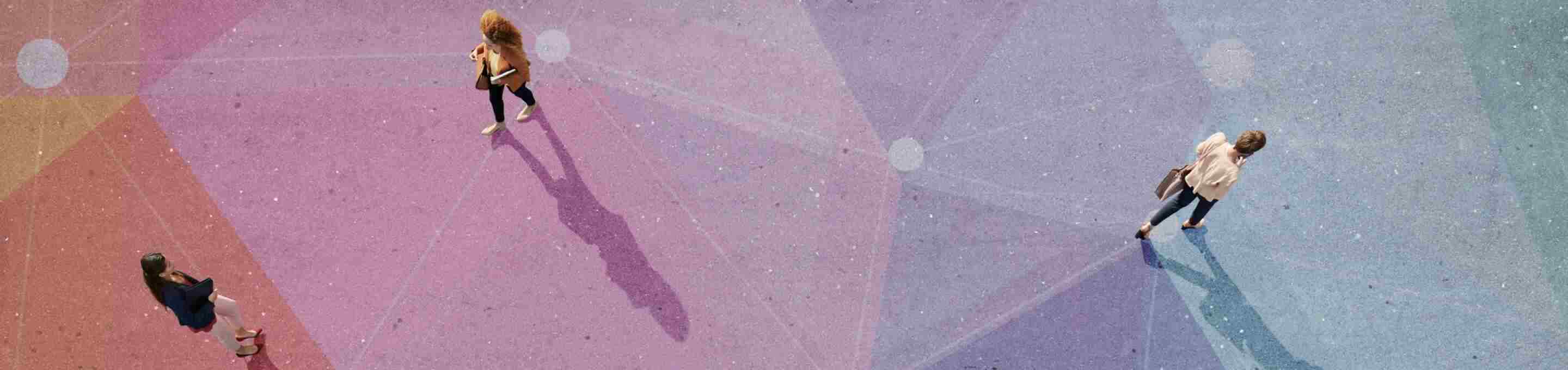 people walking over asphalt painted with colorful geometric shapes