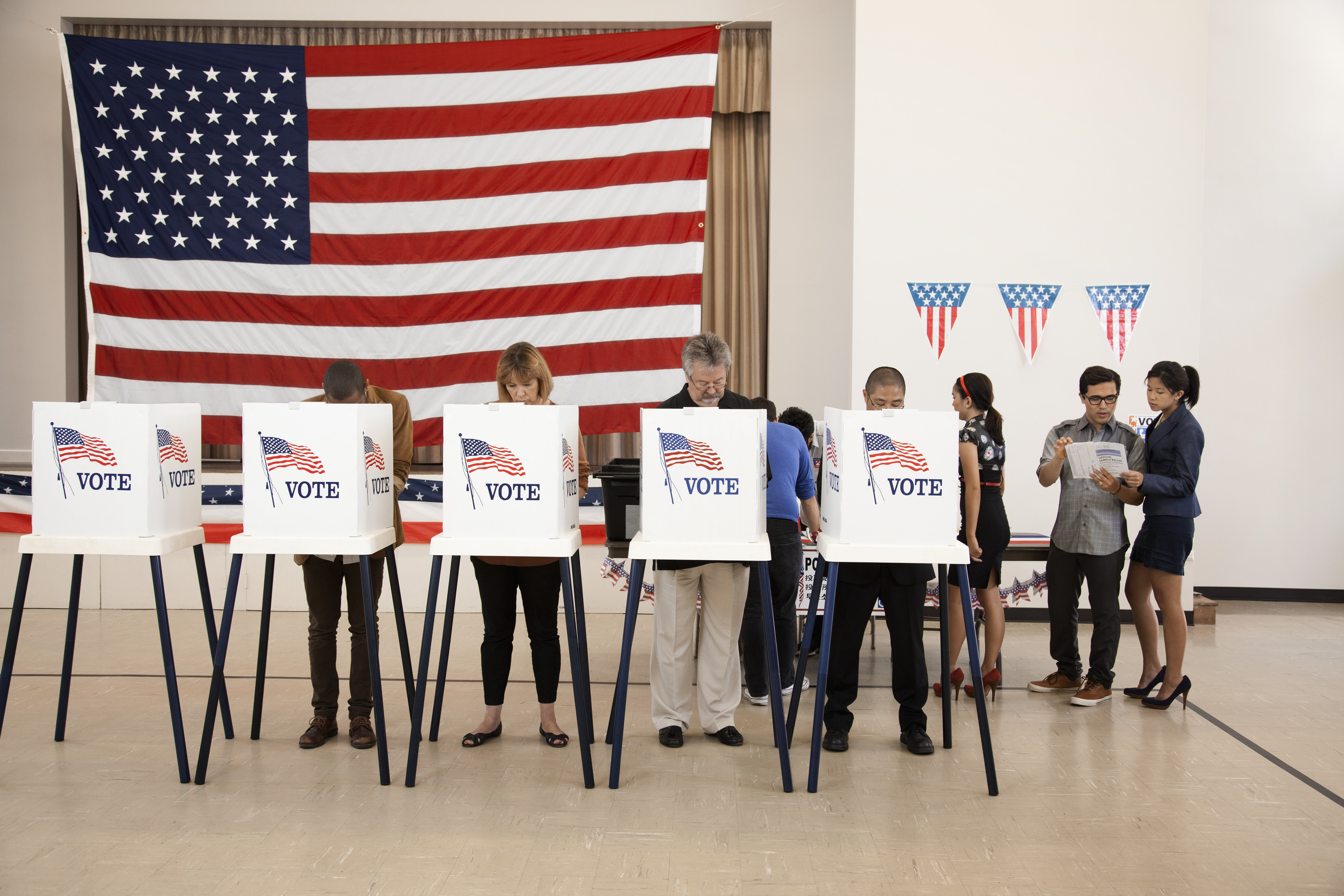 People in voting booths.