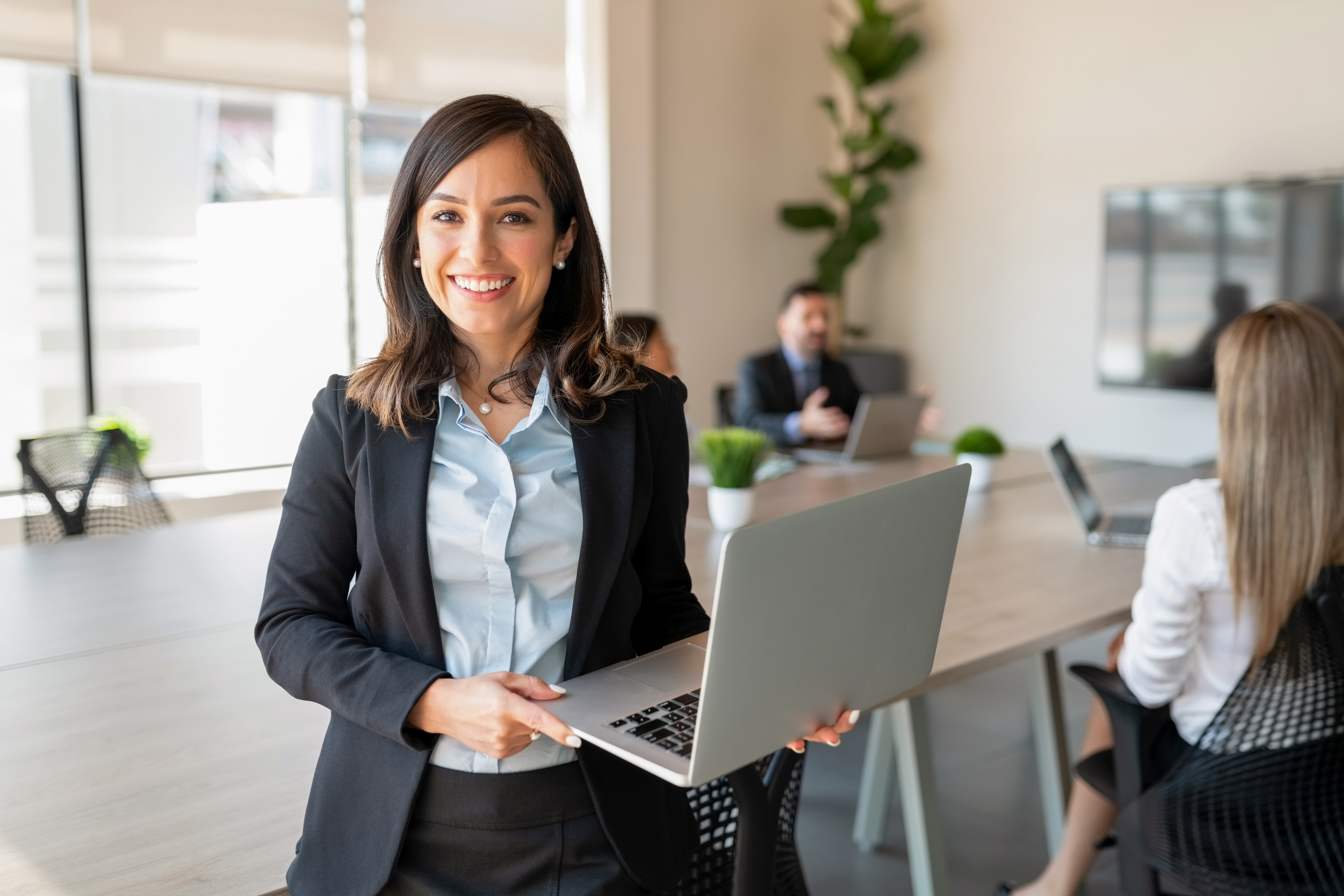 Portrayal of a Capella University online data analytics student in a conference room