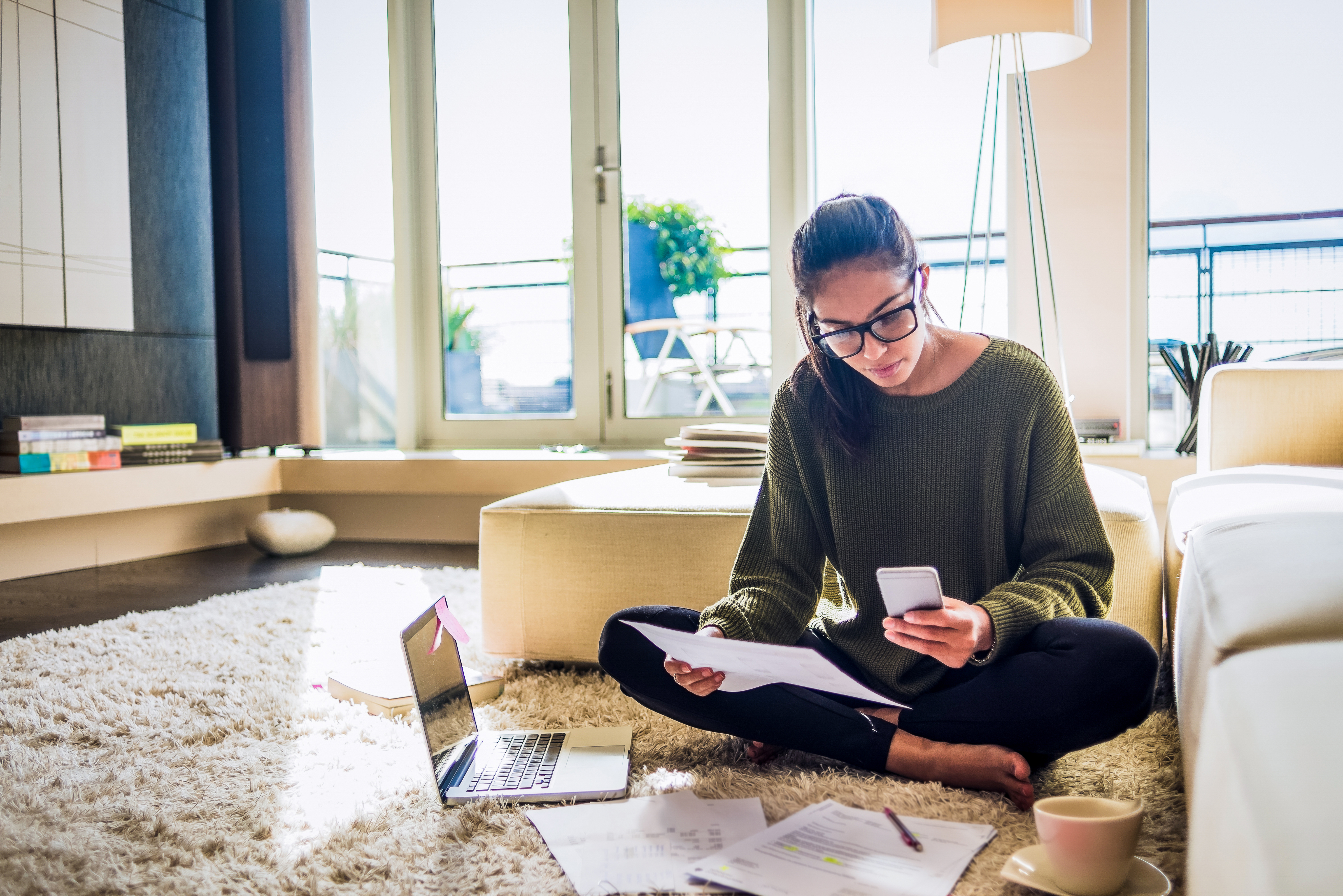 Portrayal of a Capella University online accelerated nursing degree student studying in a living room