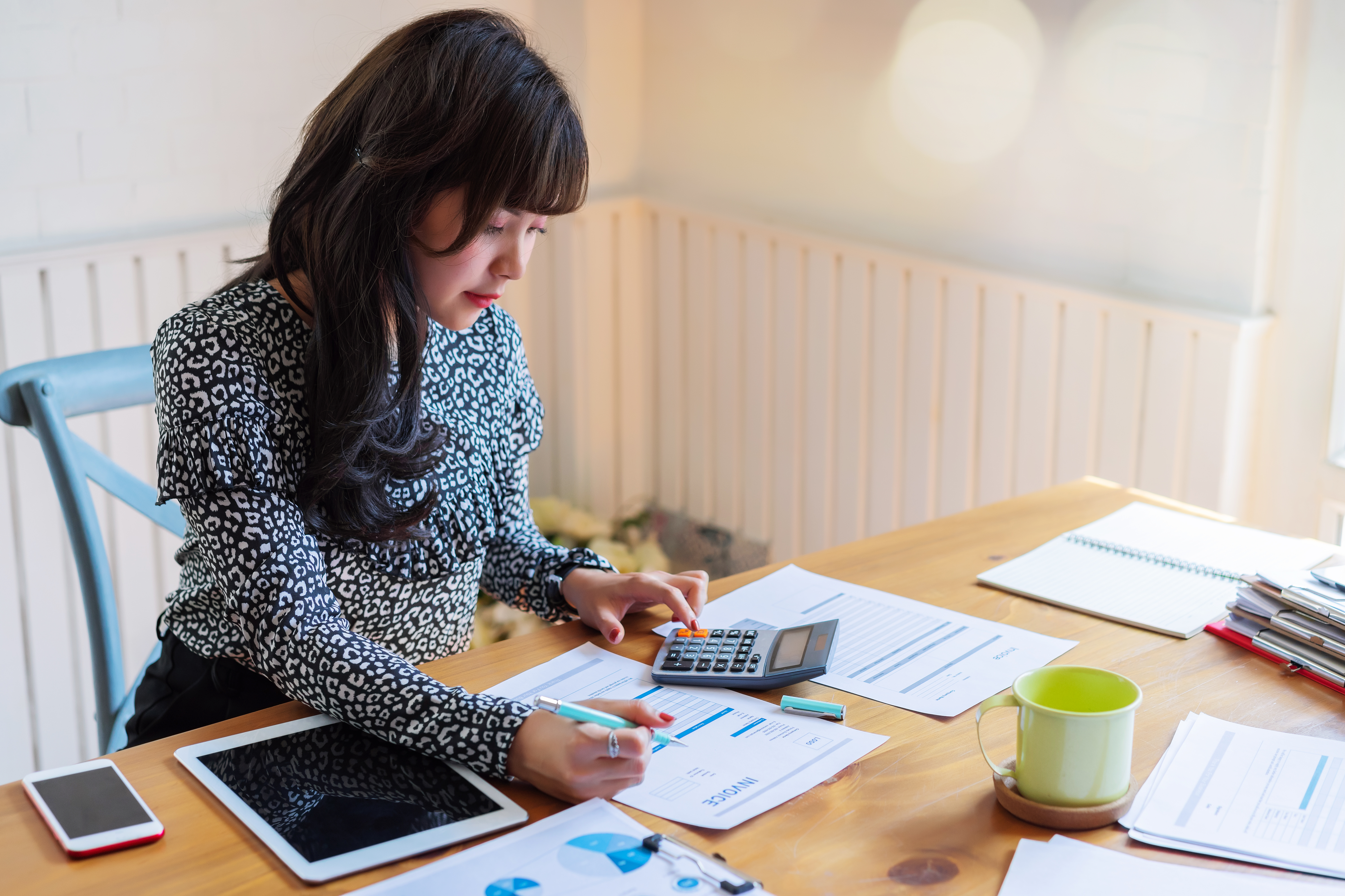 Portrayal of Capella graduate doing business paperwork.