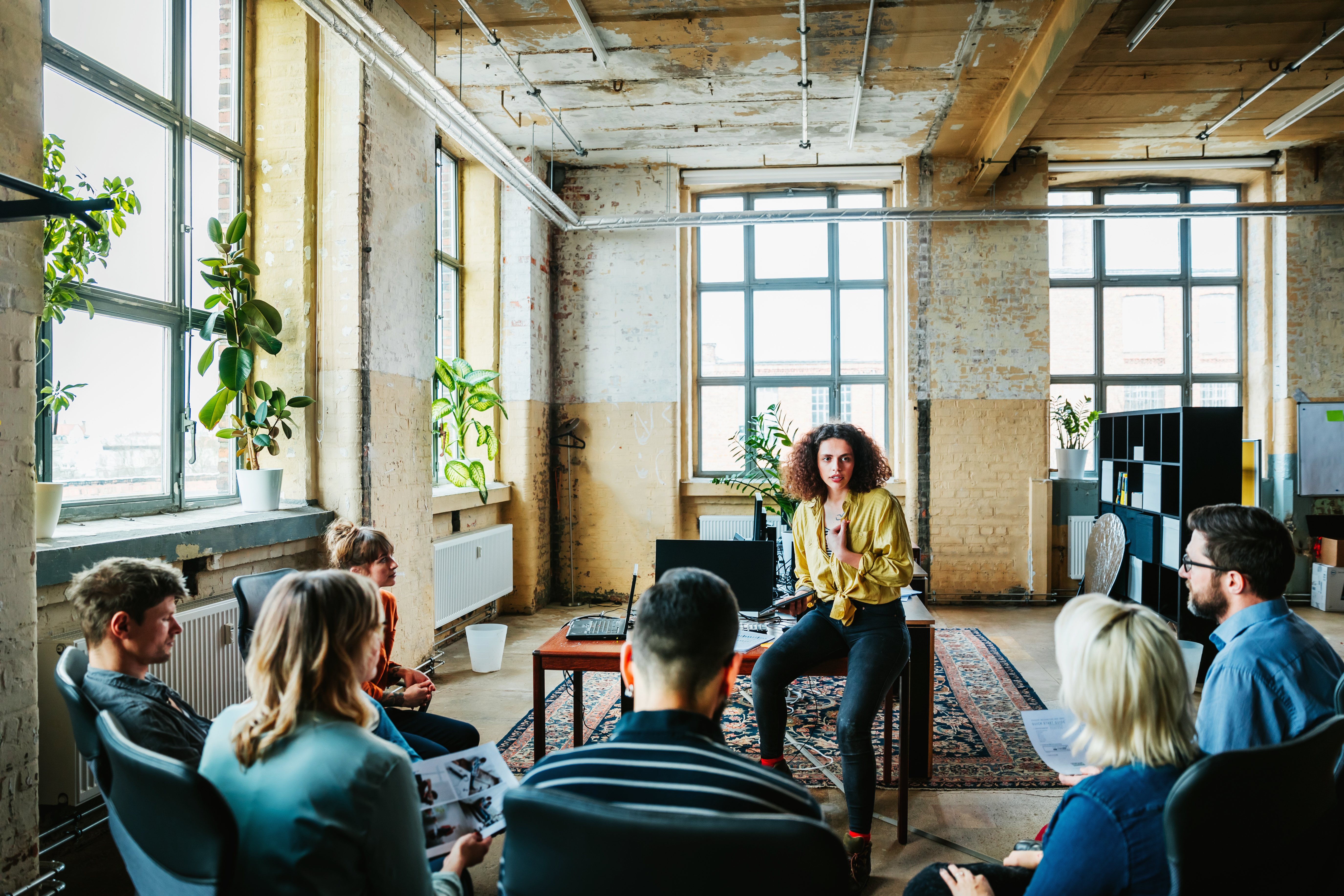 Portrayal of Capella doctoral business student leading a meeting
